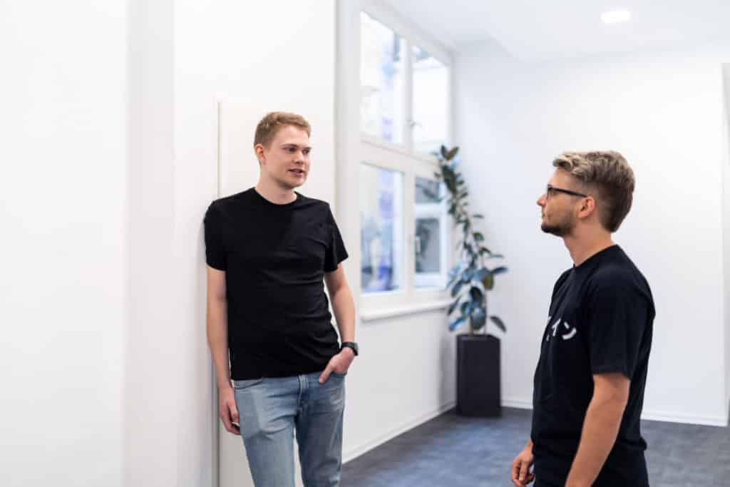 Two men talking in the office hall